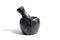 Black stone mortar with pestle stands on white background ÐžÐ¿Ð¸ÑÐ°Ð½Ð¸Ðµ